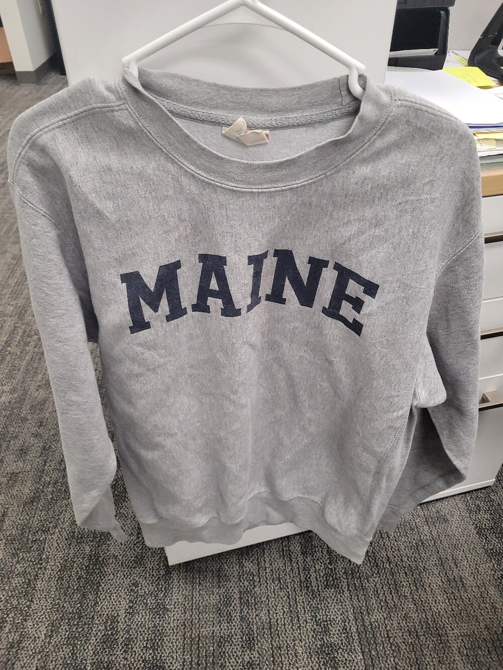 Gray Maine crewneck sweatshirt with navy blue arched text reading 'MAINE'